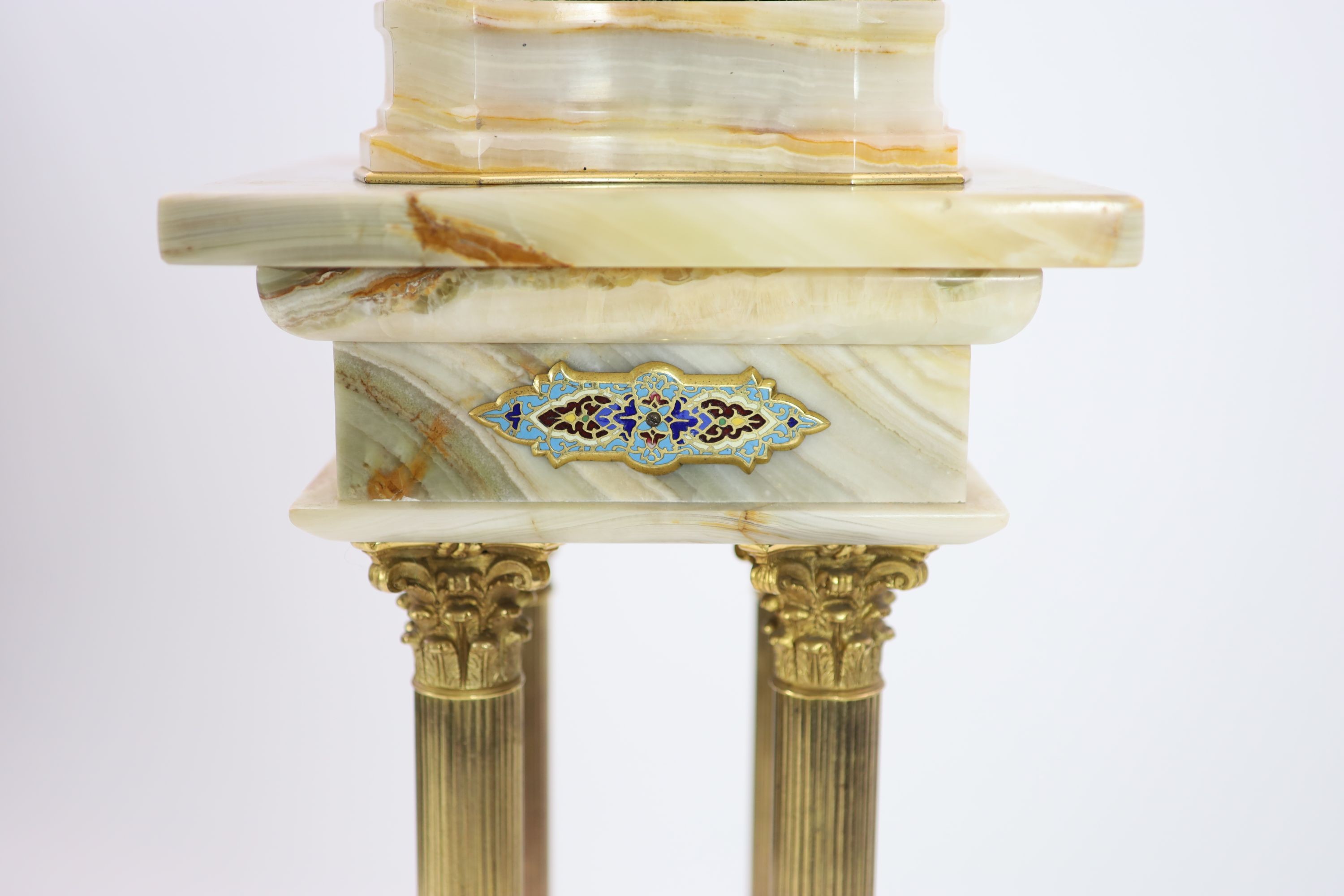A pale cream onyx, gilt bronze and champlevé enamelled pedestal urn on swept supports with swag and satyr mask decoration and a similar onyx, gilt bronze and champlevé enamelled torchere Urn H 41cm. W 22cm. Pedestal H 10